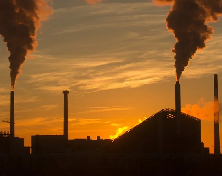 a factory with smoke coming out of it
