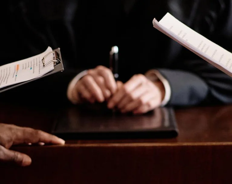a close-up of hands with papers
