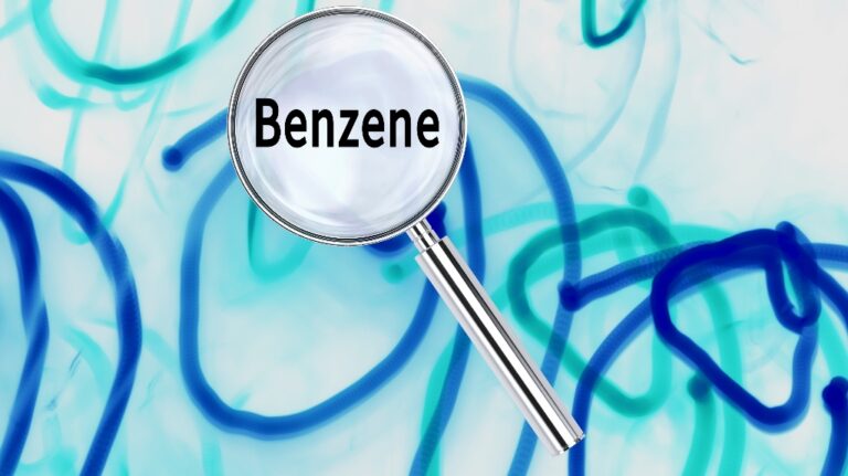 Magnifying lens over background with text Benzene