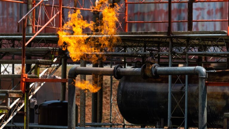 Oil pipeline explosion and billowing fire flames at fuel gas station