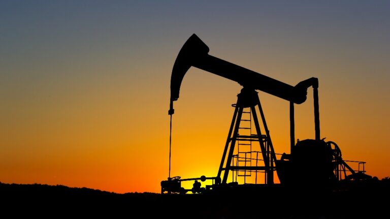 Oil pump silhouette over sunset sky