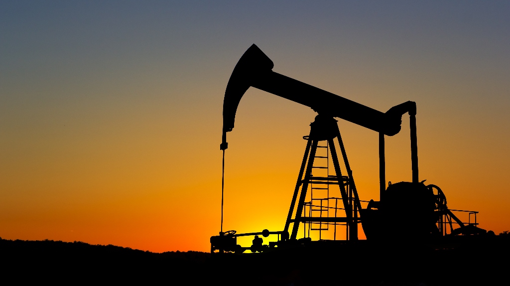 Oil pump silhouette over sunset sky