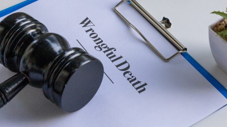 wrongful death document in a clipboard with a judge's gavel